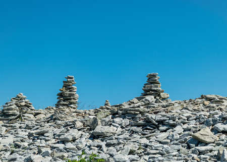 picture with beautiful white stone piles by the sea, these objects were built by travelers, Saaremaa Island, Estoniaの写真素材