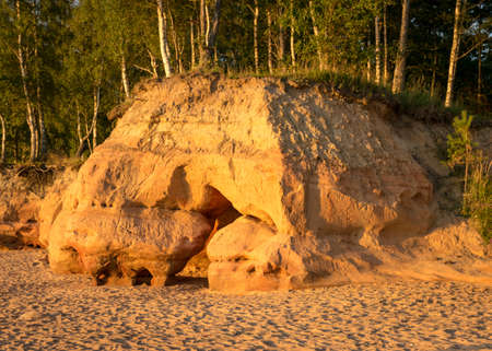 Sandstone cliffs in sunset light, golden hour before sunset, summer eveningの写真素材