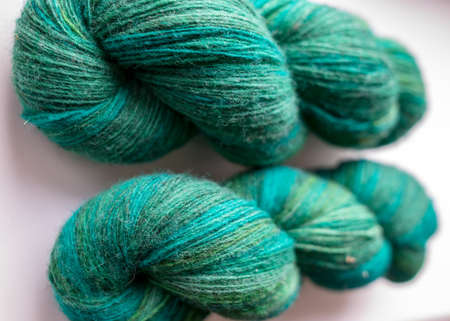 photo with skeins of colorful, variegated, green natural wool yarn, knitting and handicraft conceptの写真素材