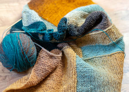 photography with colored knitting, needles and a ball of wool yarn, knitting as a hobby, handmadeの写真素材