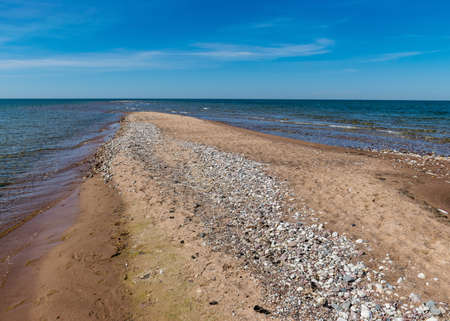 traditional sunny summer landscape with sandy and pebbly promontory, blue sea and sky, Harilaid Nature Reserve, Estonia, Baltic Seaの写真素材