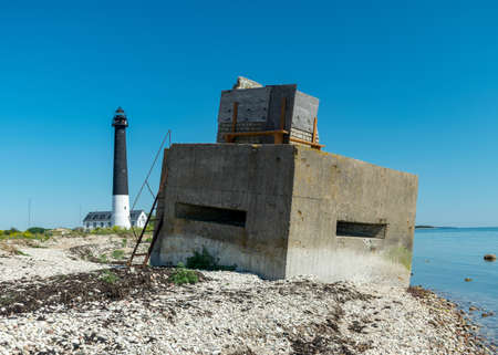 sunny summer landscape with a rocky sea shore, remnants of an old concrete structure in the water, Saaremaa Island, Sorves Peninsula, Estoniaの写真素材