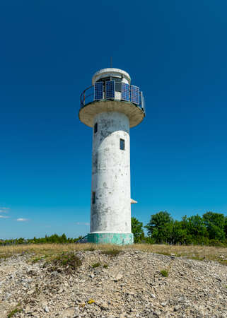 summer view of an old abandoned lighthouse by the sea, Saaremaa Island, Estoniaの写真素材
