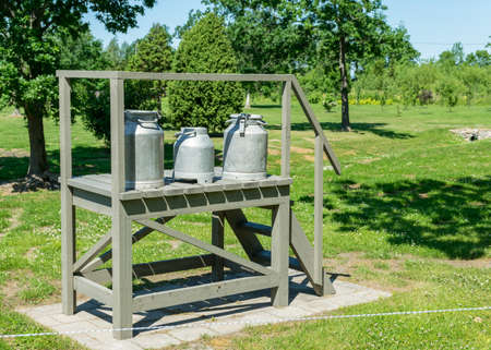 beautiful summer landscape with a wooden wooden structure and a milk jug on it, Saaremaa Island, Estoniaの写真素材