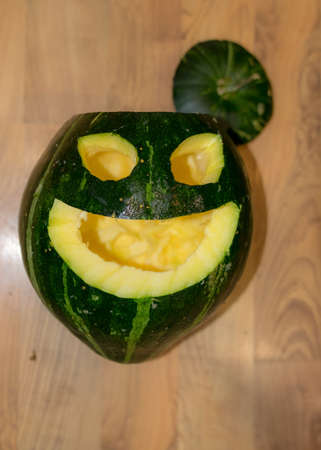 Preparing for Halloween, pumpkin carving, green carved pumpkin for Halloween, Halloween Jack o Lanterns, autumnの写真素材