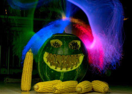 green carved pumpkin figure, halloween, colorful light painted background, green halloween jack o lanterns, halloween, autumnの写真素材