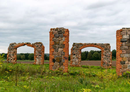 landscape with stone and brick barn ruins reminiscent of one of the world's wonders stone monument Stonehenge in Great Britain, Smiletne, Latviaのeditorial素材