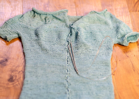 picture with light blue cotton sweater, knitting close-up, handmade, knitting as a hobbyの写真素材