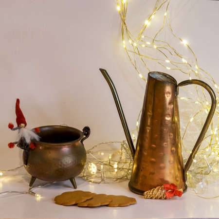 copper cup and pot decor, gingerbread and other Christmas attributes, white light chain background, Christmas waiting time, winter timeの写真素材