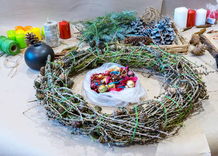Christmas handmade diy background. Making craft xmas wreath and ornaments. Workplace for preparing handmade new year decorations. Winter holidays concept. Home leisure, tools, trinkets and details for holiday decorations,  Creative christmas diyの写真素材