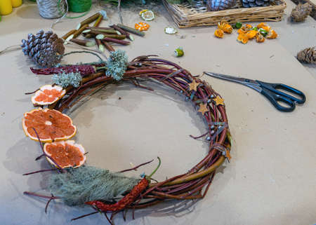 Christmas handmade diy background. Making craft xmas wreath and ornaments. Workplace for preparing handmade new year decorations. Winter holidays concept. Home leisure, tools, trinkets and details for holiday decorations,  Creative christmas diyの写真素材