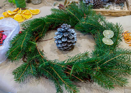 Christmas handmade diy background. Making craft xmas wreath and ornaments. Workplace for preparing handmade new year decorations. Winter holidays concept. Home leisure, tools, trinkets and details for holiday decorations,  Creative christmas diyの写真素材