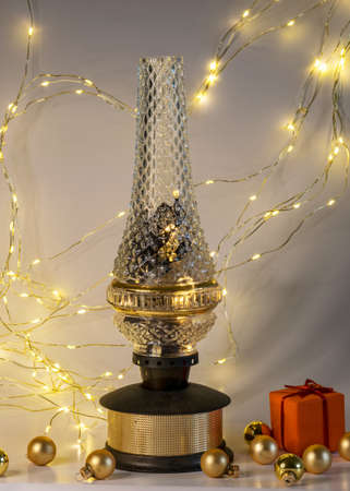 antique lamp, golden glass balls and various Christmas decorations, illuminated background of a chain of white lights, Christmas waiting time, winterの写真素材