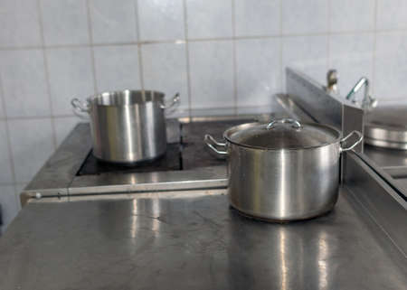 metal pot on the stove top, school kitchen, eat cooking conceptの写真素材