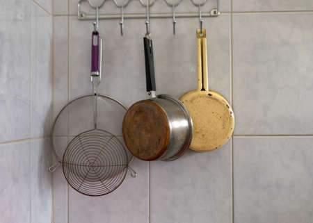 various kitchen utensils on the hanger on the wall, eat cooking conceptの写真素材