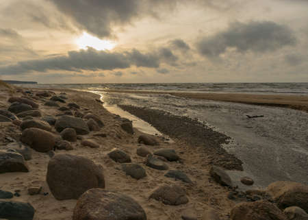 landscape with sea shore, rocks in water and sand, winter, December, Vidzeme rocky seashore, Latviaの写真素材