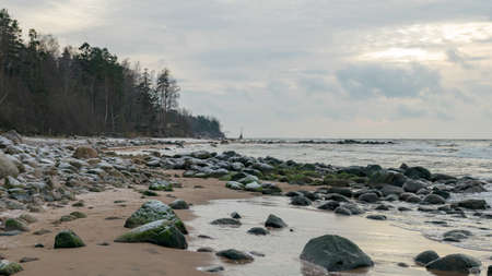 landscape with sea shore, rocks in water and sand, winter, December, Vidzeme rocky seashore, Latviaの写真素材