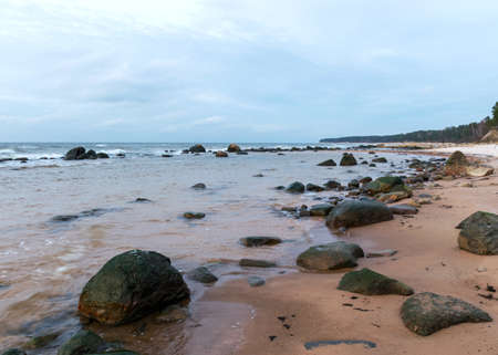 landscape with sea shore, rocks in water and sand, winter, December, Vidzeme rocky seashore, Latviaの写真素材