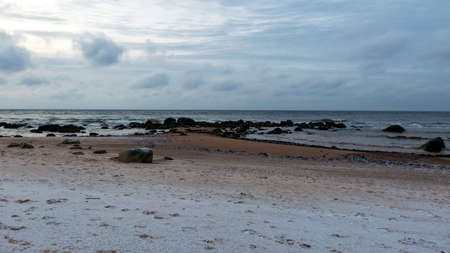landscape with sea shore, rocks in water and sand, winter, December, Vidzeme rocky seashore, Latviaの写真素材