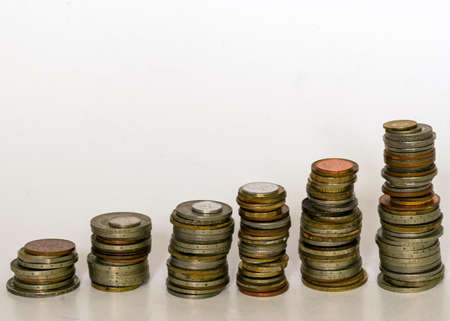 photography with metal coins of different shapes, countries and values, in columns of different heightsの写真素材