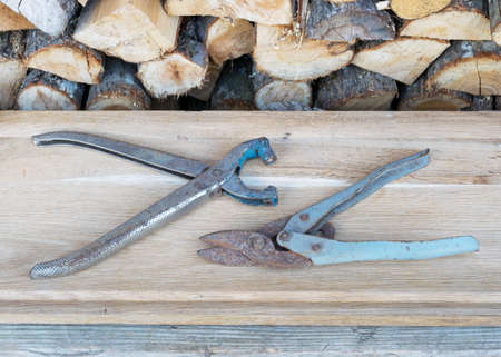 photo with antique iron scissors on wooden background, rusty tools, metal waste, scrap metalの写真素材