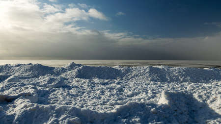 winter landscape by the sea, snowy pieces of ice by the sea, dunes covered with a white layer of shining snow, winterの写真素材