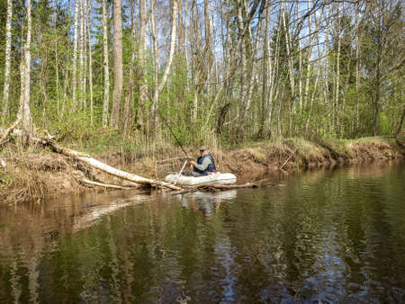 landscape with wild river, boat fisherman, spring landscapeの写真素材