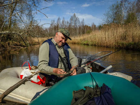 landscape with wild river, boat fisherman, spring landscapeの写真素材