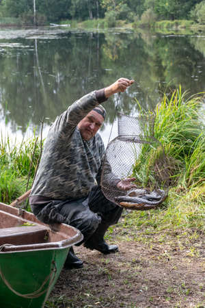 photography with a fisherman who finds his fish, fishing concept, fishing as a hobby, outdoor recreationの写真素材