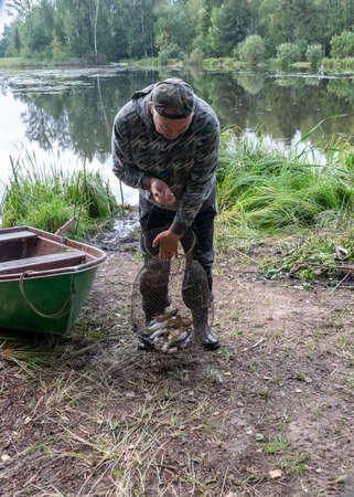 photography with a fisherman who finds his fish, fishing concept, fishing as a hobby, outdoor recreationの写真素材