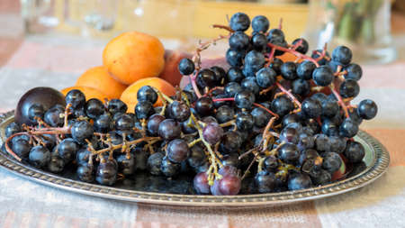 photo with fruit fragments on a metal tray, grapes, plums, peaches, apricots, autumn harvest time, healthy diet and vitamins, autumnの写真素材
