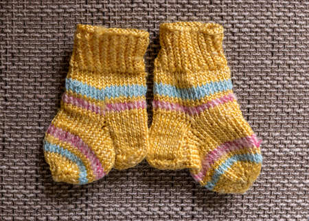 photography with beautiful, variegated small children's socks, handmade, wool yarn, knitted textureの写真素材