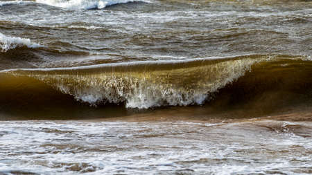 beautiful wave on the beach, background blur and waves in sunlight, dramatic natural background, waves and splashes of water, Vidzeme rocky seashore, Salacgriva rural area, Latviaの写真素材
