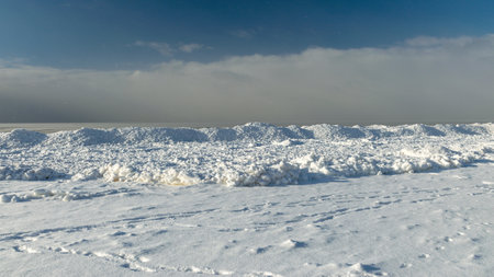 winter landscape by the sea, snowy pieces of ice by the sea, dunes covered with a white layer of shining snow, winterの写真素材