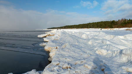 winter landscape by the sea, snowy pieces of ice by the sea and ice texture at sea, dunes covered with a layer of white snowの写真素材