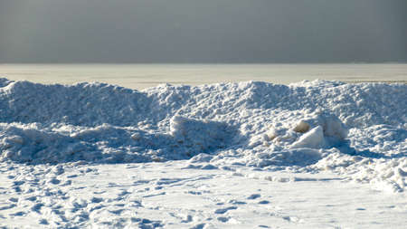 winter landscape by the sea, snowy pieces of ice by the sea, dunes covered with a white layer of shining snow, winterの写真素材