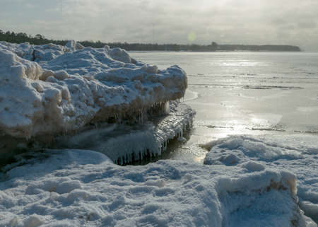 winter landscape by the sea, snowy pieces of ice by the sea, dunes covered with a white layer of shining snow, winterの写真素材