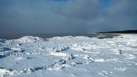 winter landscape by the sea, snowy pieces of ice by the sea, dunes covered with a white layer of shining snow, winterの写真素材