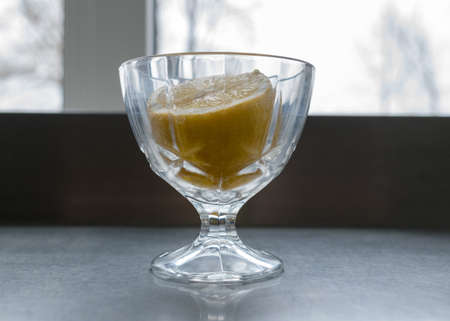 cut lemon in a glass container, cooking additives