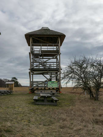 landscape with seaside meadow in spring, wooden walkway and bird watching tower, Randu plavas, Latviaの写真素材