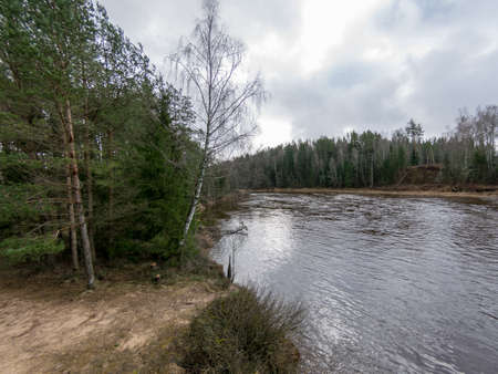 Landscape with river and clouds glare, early spring, Gauja, Latvia