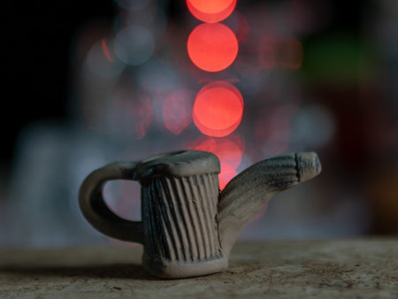 beautiful small retro clay mugs close-up view on a blurred backgroundの写真素材