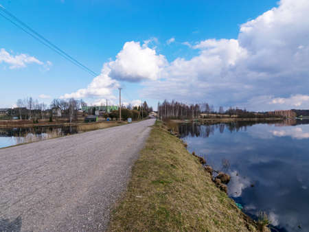 landscape with road, beautiful lake, clouds