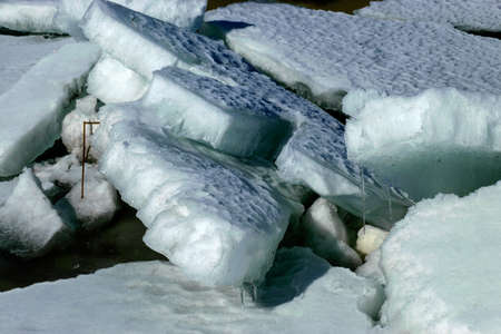 spring landscape with the lake shore, the lake surface is covered with ice, early spring in nature