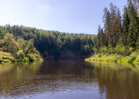 beautiful morning on the river, shore and tree reflections in the water, Gauja river, Latvia