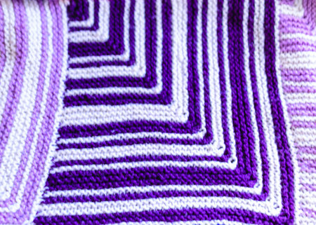Close-up background image of a patchwork quilt with a colorful graphic design, knitting texture,...