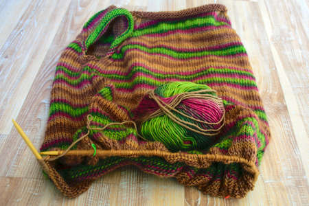 Crocheted knitted squares, multicolored, warm knitted fabric sweater, knitting texture, fuzzy...
