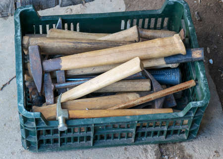 photo with scrap metal from various spare parts, rusty old antique iron hammers, scrap metal