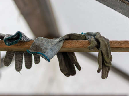 picture with dirty gardener gloves on a wooden board