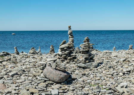 picture with beautiful white stone piles by the sea, these objects were built by travelers, Saaremaa Island, Estoniaの写真素材